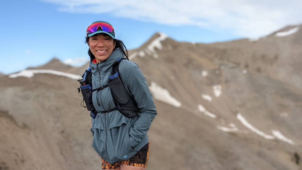 Mexican Filipina mountain runner smiles on a mountain saddle. Photo Vanessa Chavarriaga Posada.